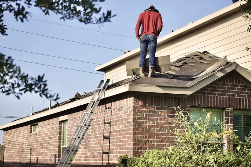 Professional roofer working on a residential roof in Mulino